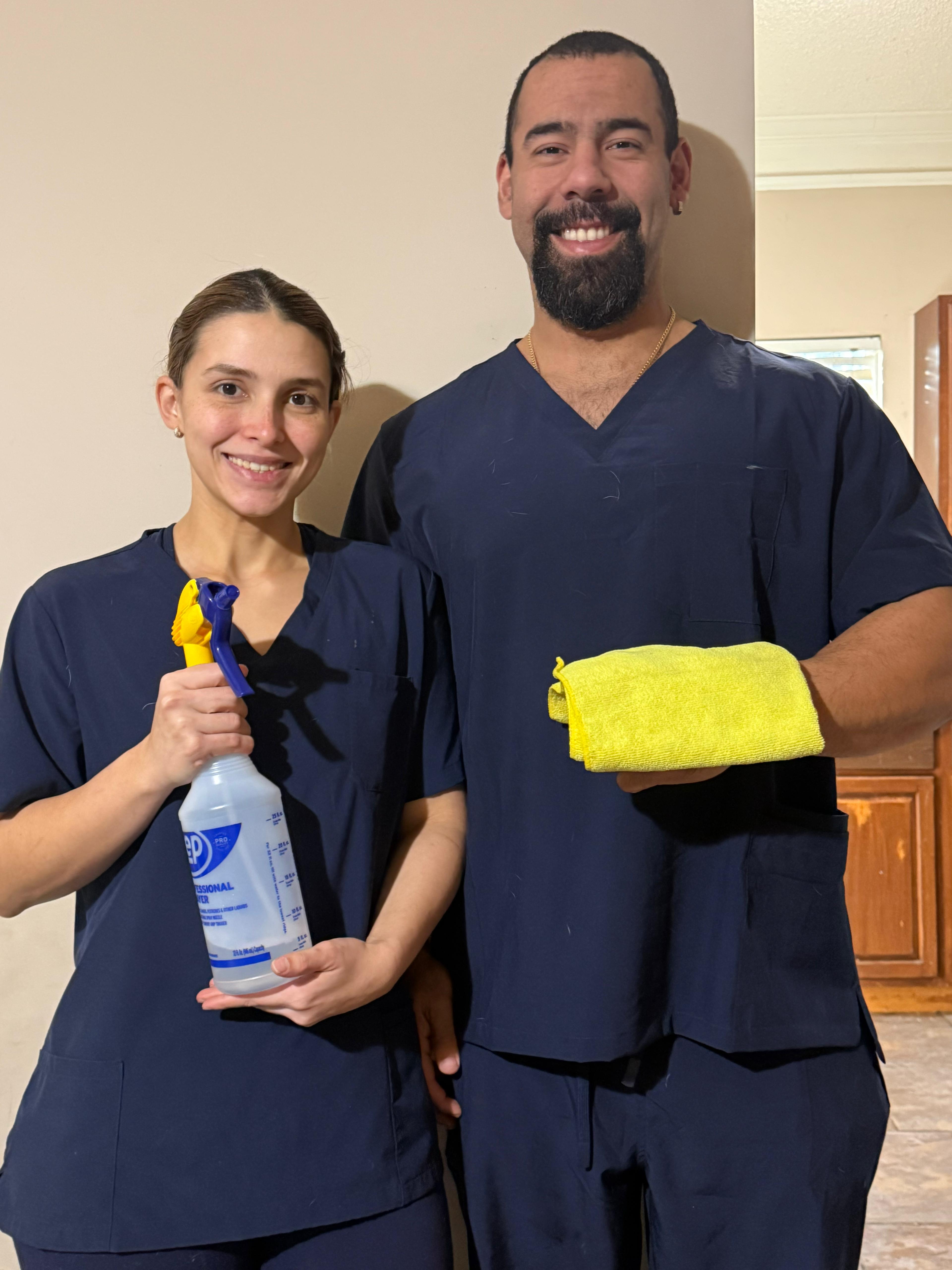 Cleaning team organizing supplies in a bright room